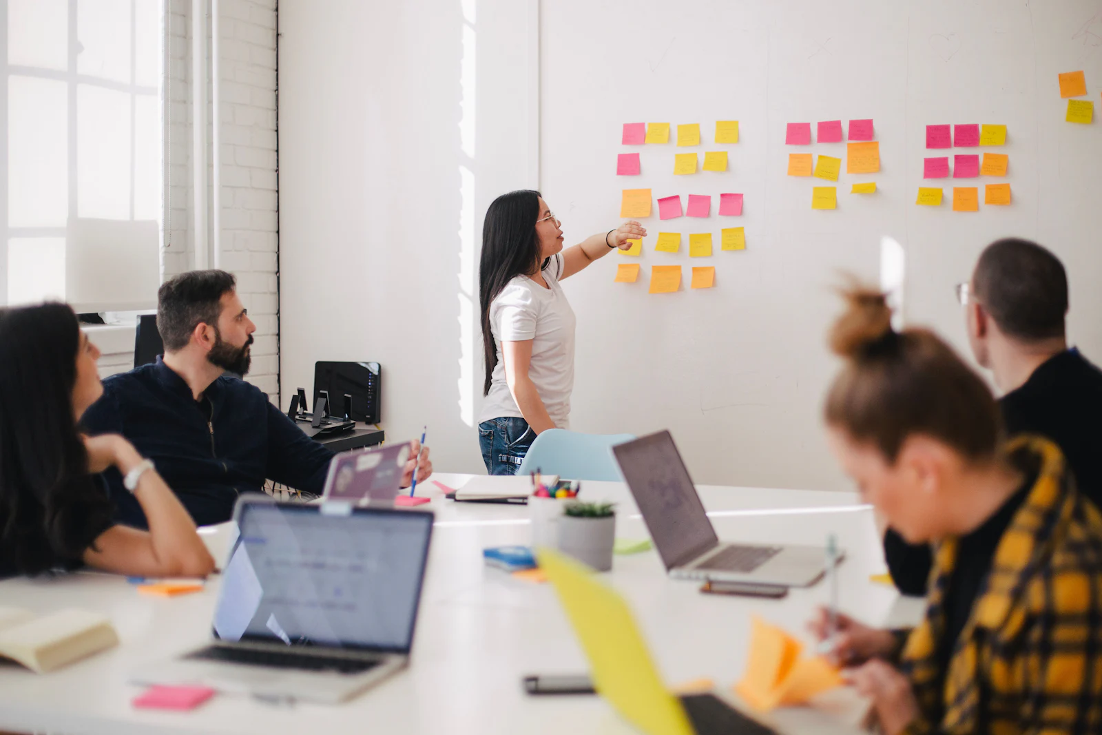 Team planning a containerized application architecture on a whiteboard